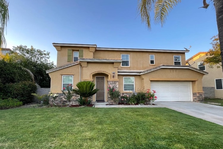 exterior of 41848 Pepper Tree; two-story beige stucco house with nice landscaping
